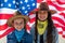 Independence Day. Patriotic holiday. Happy kids, cute two girls with American flag. Cowboy