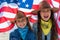 Independence Day. Patriotic holiday. Happy kids, cute two girls with American flag. Cowboy. USA celebrate 4th of July