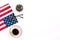 Independence day of USA with flag, glasses, coffee, plant on white background top view space for text