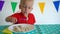 Independent cute toddler boy eat dumpling with fork. Gimbal movement forward