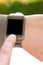 Index finger on a partially isolated smartwatch