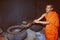 India: A buddhist monk preparing herbal ayurevedic medicinin Thiruvananthapuram, Kerala