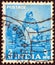 INDIA - CIRCA 1955: A stamp printed in India from the `Five Year Plan` issue shows a woman spinning, circa 1955.