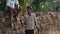 INDIA, GOA - 2012: Boys are playing cricket on a field of village