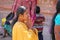 India, Hampi, 01 February 2018. An Indian woman in a bright yellow sari folded her arms in a namaste