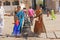 India, Hampi, 01 February 2018. Indian women and children are posing next to a figure or statue of a connected cow