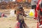 India, Hampi, 02 February 2018. A small poor and dirty Indian girl playing with sunglasses. A little girl in big glasses from the