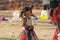 India, Hampi, 02 February 2018. A small poor and dirty Indian girl playing with sunglasses. A little girl in big glasses from the