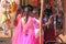 India, Hampi, 02 February 2018. Young girls in bright pink saris are buying something on the market