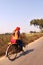 India, the Indian street scene of local life, young girl going in college by cycling in red dress