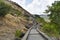 INDIA, MAHARASHTRA, PUNE, May 2023, People at steps to the Bhaja Caves, Ancient Buddhist built in 2nd century BC, during the