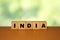 INDIA message word on a wooden desk on cube blocks