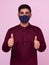 Indian adult boy wearing mask with thumbs up gesture
