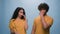 Indian Arabian ethnic couple man woman girl guy funny shock reaction in studio blue background cover nose bad smell