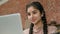 Indian arabian woman businesswoman waitress barista cafe owner looking laptop screen checking checking online delivery