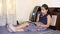 Indian Asian Girl Child studying turning pages of book while sitting on bed spreading legs