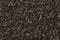 Indian Assam black Harmutty dried tea leaves full frame close up
