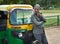 An Indian auto driver waiting for passengers in front of india gate in New Delhi, India