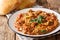 Indian Baingan Bharta eggplant, with tomatoes, garlic and spices close-up on a plate. horizontal