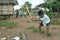 Indian boy is chopping wood with big ax, Nicaragua