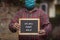 A indian boy holding slate with writing `We will fight back`