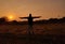 A indian boy standing in the field sunset