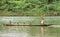 Indian boys sail with dugout canoe on river, Nicaragua