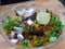 Indian breakfast Poha topped with peanuts, pomegranate seeds, chopped green chilly