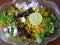 Indian breakfast Poha topped with peanuts, pomegranate seeds, chopped green chilly