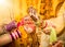 Indian bride hands getting decorated. Focus on hand