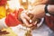 Indian bride ties with holy thread on her wrist at ceremony focus on hand with blurry background