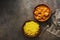 Indian and British dish spicy chicken tikka masala with rice on a dark rustic background. Top view, flat lay