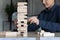 Indian businesswoman build tower of wooden blocks play build game