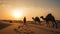 Indian cameleers bedouin with camel silhouettes in sand dunes of Thar desert on sunset. Generative ai