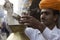 Indian Chai Worker pouring some Tea