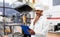 Indian chef with menu on clipboard at kebab shop