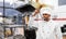 Indian chef tasting food from ladle at kebab shop