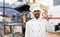 Indian chef in toque showing ok at kebab shop