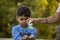 Indian child coughing on his elbow showing tips to protecting corona virus