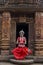 Indian classical odissi dancer pose against the backdrop of temple with sculptures