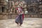Indian classical odissi dancer wears traditional costume and posing in front of Mukteshvara Temple,Bhubaneswar, Odisha, India
