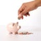 Indian clay piggy bank with human hand finger dropping coin on white background