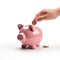 Indian clay piggy bank with human hand finger dropping coin on white background