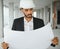 Indian construction site manager standing wearing helmet, thinking at construction site. Portrait of mixed race manual