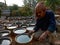 An indian craft man filling water at cements pot in open workshop in india oct 2019