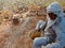 An indian craft old man making dry grass chair making task at agriculture field in india oct 2019