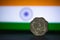 Indian currency - Indian 10 Paisa coin rupee isolated on india flag background. old ten paisa coin with space for copy text