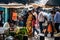 Indian customers shopping at a busy vegetable market in the city of Mysuru