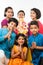 Indian Cute kids holding statue of Lord Ganesha or Ganapati on Ganesh festival or chaturthi, welcoming god. Asian small boys and g