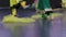 Indian dance. Close-up of the feet of young dancers on stage. Yellow and green clothes.